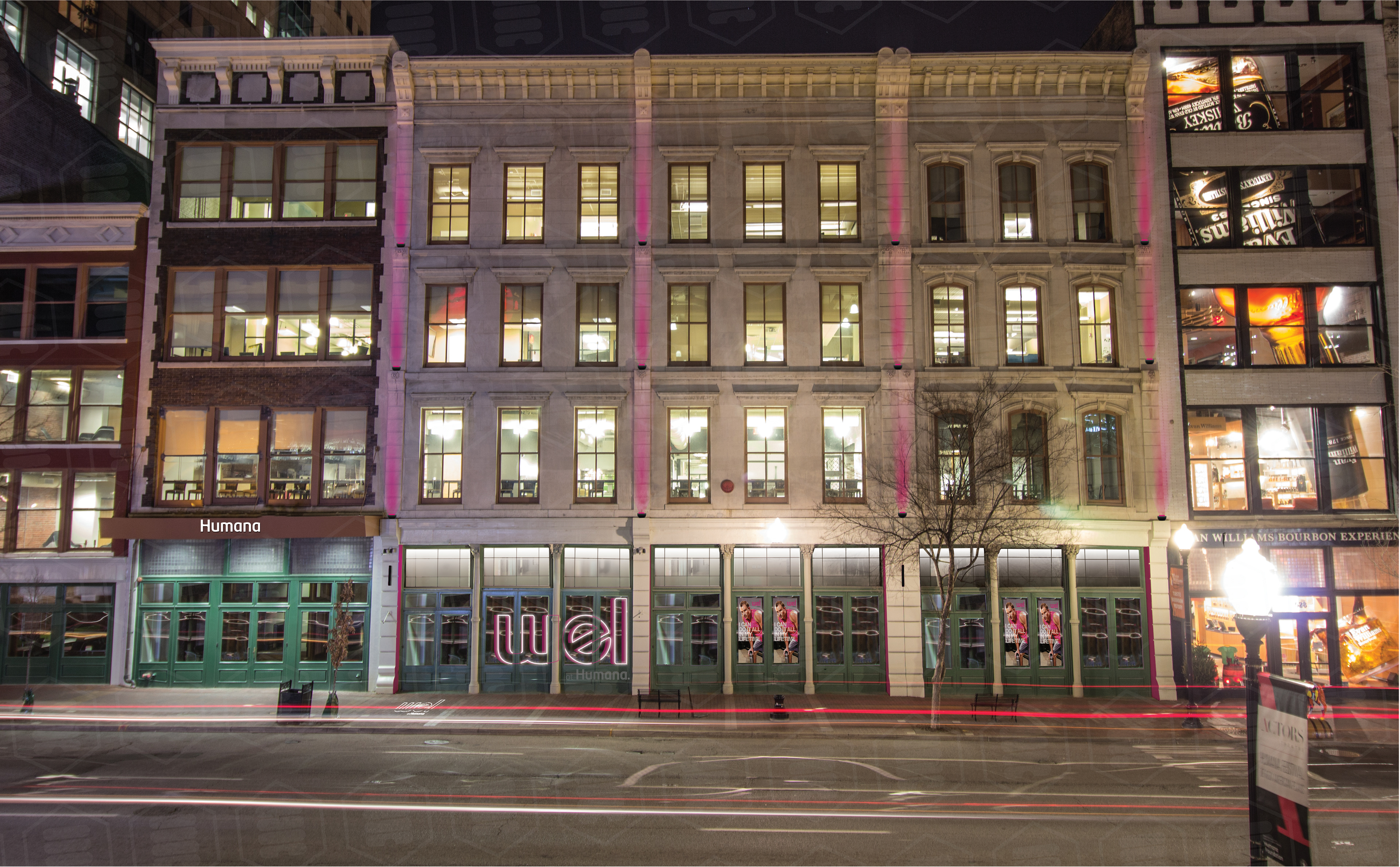 Wel at Humana storefront on Main Street, Louisville - neon signage illuminated at night